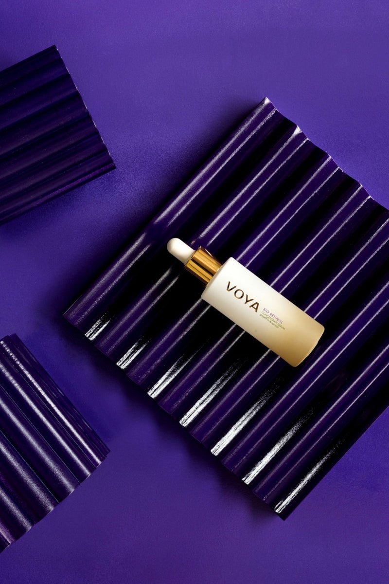 voya bio retinol face serum lying on a purple frame